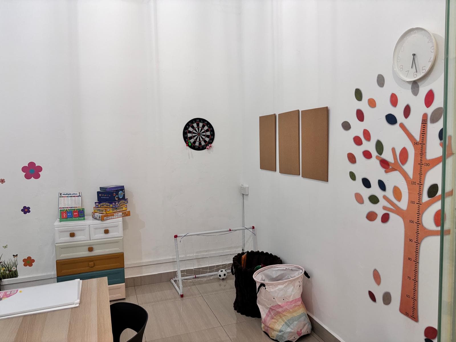 Activity corner with a mini football goal, dartboard and a tree growth chart
