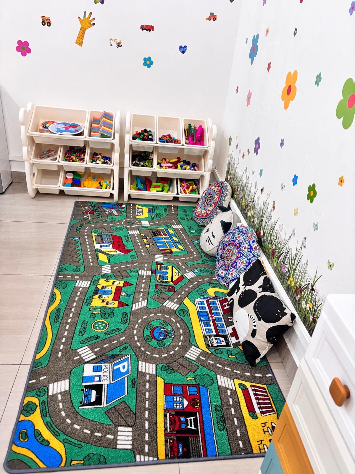 Play corner with a city road play mat, toy storage and cushions